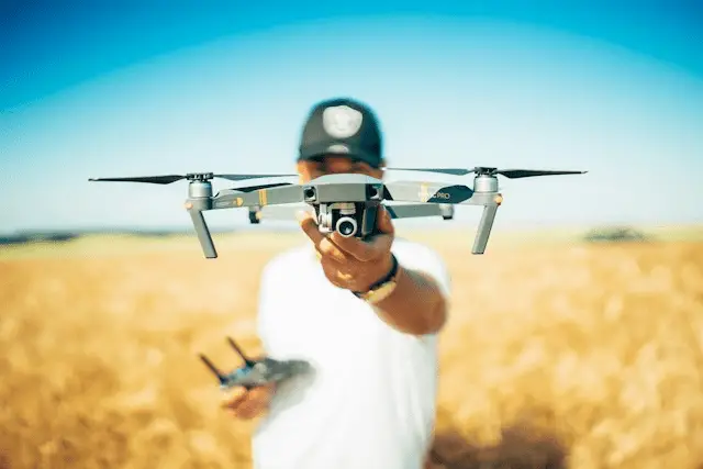 Modern Farming Techniques, a farmer standing on his farm with a drone in his hand